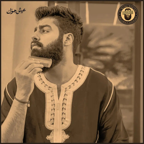 A man combing and arranging his beard