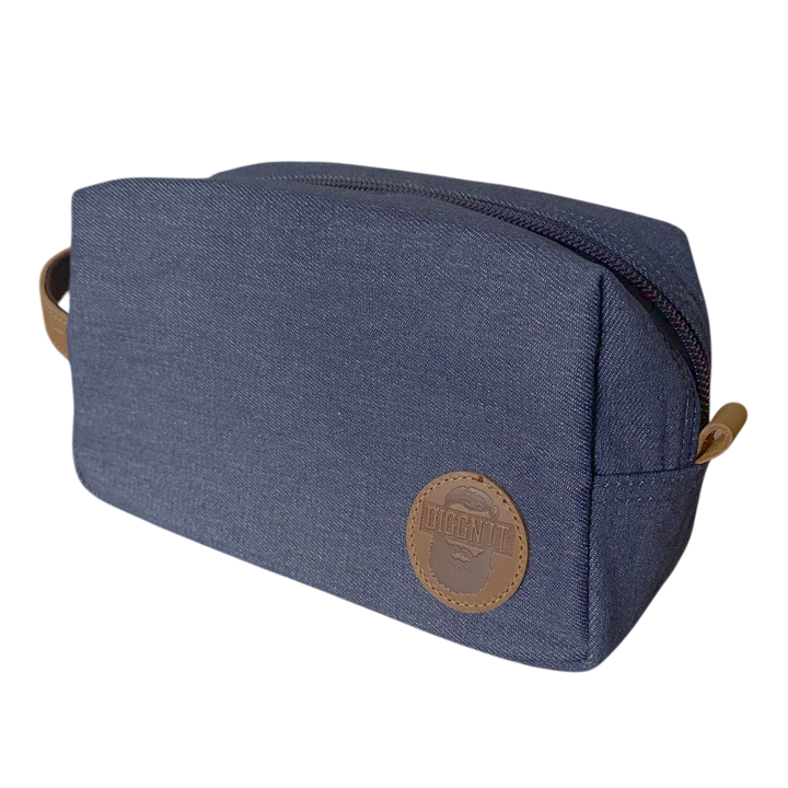 Blue toiletry bag with a brown leather patch on a white background