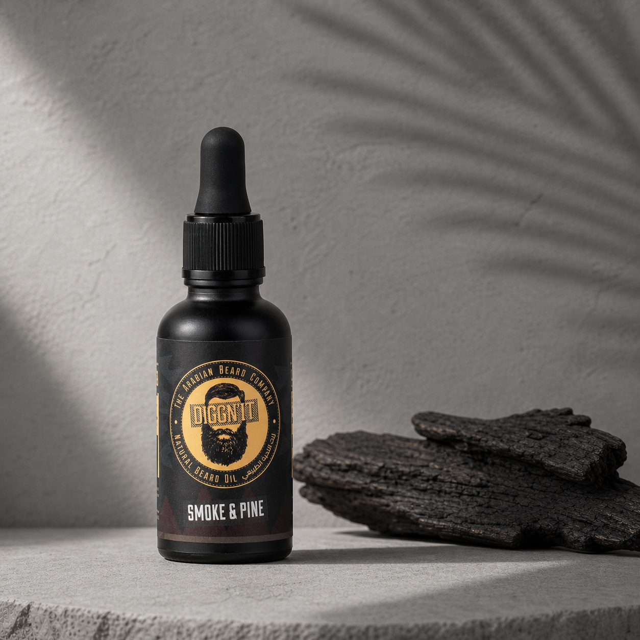 Diggn'It Smoke & Pine Arabian Beard Oil bottle beside charred wood